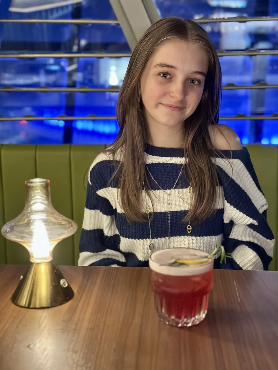 Manon Maindivide casual photo in a striped sweater at a restaurant table