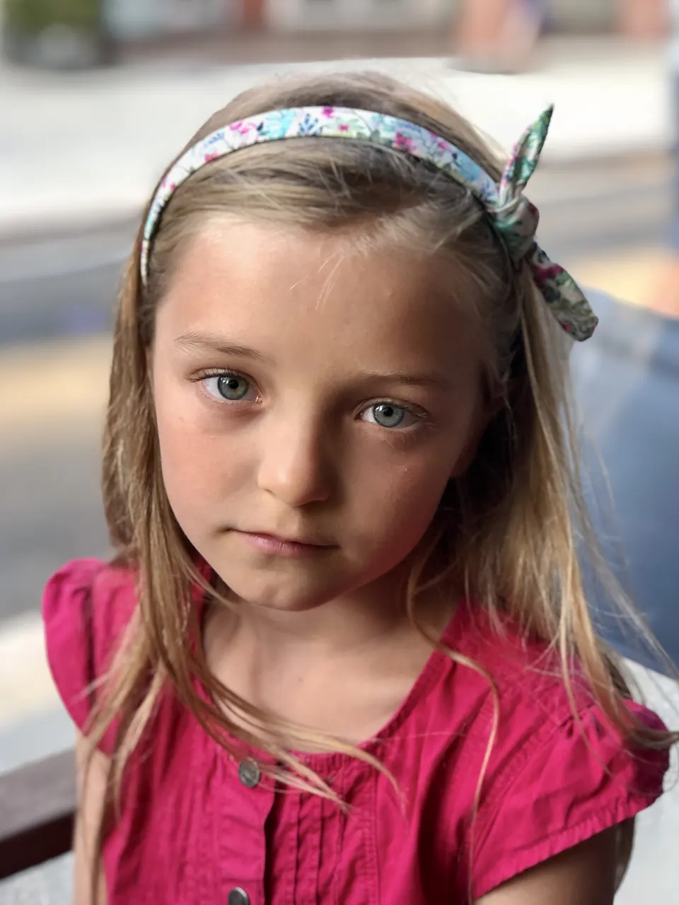 Manon Maindivide portrait in a pink top and floral headband, with a calm gaze