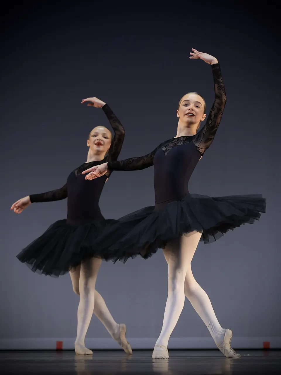 Manon Maindivide dance performance in a black lace tutu, posing en pointe with a partner