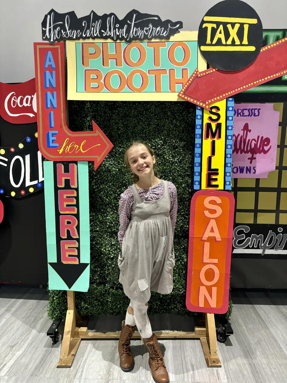Manon Maindivide casual photo at a colourful photo booth with neon-style signs
