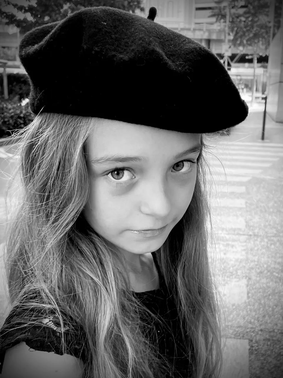 Manon Maindivide black and white portrait wearing a black beret, looking into the camera
